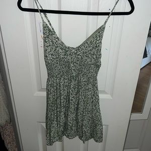 Green mini dress in good condition with white flowers